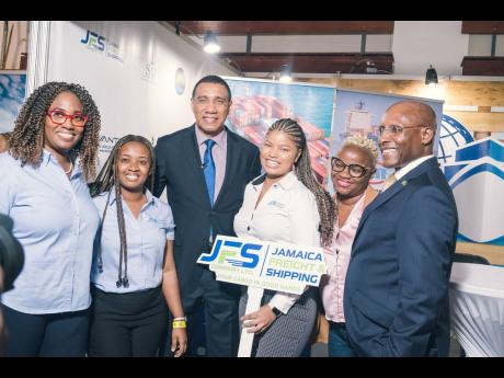 Members of the Jamaica Freight and Shipping Company Limited share lens time with Prime Minister of Jamaica Andrew Holness (third left) and Minister of Industry, Investment and Commerce Senator Aubyn Hill (right), at the opening of Expo Jamaica 2023 at the 