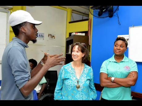From left: Chadae King relates how the Teen Hub has been able to help him to UNICEF Jamaica Representative Olga Isaza, and Juliet Cuthbert-Flynn, minister of state in the Ministry of Health and Wellness, during a tour of the centre on Monday.
Kenyon Hemans
