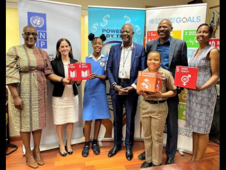 From left:  UNDP Resident Representative Denise E. Antonio; Deputy Director for UNDP in Latin America and the Caribbean Linda Maguire; Roniah Jule, student of beneficiary school Constant Spring Primary; Chief Executive Officer of the Universal Service Fund