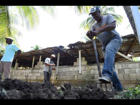 Leslie Anderson prepares a nursery for coconut seedlings during a training session by representatives from the Caribbean Agricultural Research and Development Institute with the Kanga Gully Farmers Group in Guts River, St Thomas, recently.