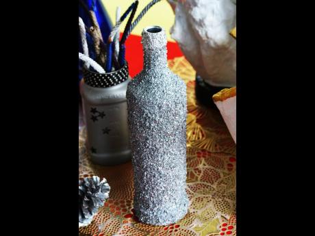 Glass bottle decorated with crushed glass, sprayed in metallic grey (silver).