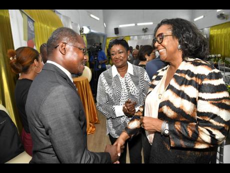 Professor Colin Gyles, President of Utech (left) speaks with media practitioner Marcia Erskine, (right) and Minna Israel, special adviser to the Vice Chancellor on Resource Development, UWI, at the J. A. Lester Spaulding Lecture luncheon.