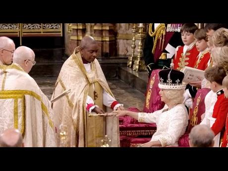 Revd Rose Hudson-Wilkin, Bishop of Dover, presents the Queen Consort Rod to the newly crowned Queen Camilla during the coronation ceremony in Westminster Abbey.