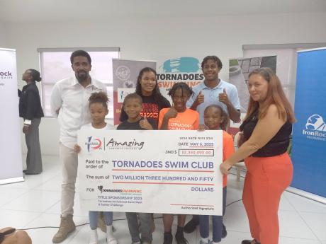 From left: Yannick Sharpe, CEO of Amazing Finishes; Kokolo Foster, former Tornadoes team captain; Zachary Jackson-Blaine, Tornadoes team captain; Wendy Lee, Tornadoes head coach along with up-and-coming Tornadoes swim club members display a sponsorship che