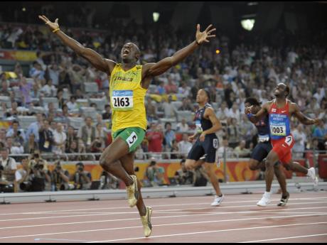 In this August 20, 2008, file photo, Jamaica’s Usain Bolt celebrates as he wins the men’s 200-metre final with a world record during the athletics competitions in the National Stadium at the Beijing 2008 Olympics, in Beijing.