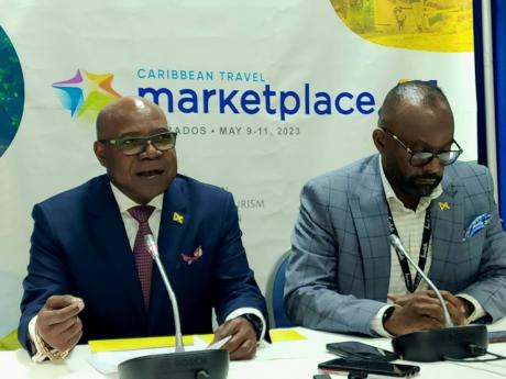 Minister of Tourism Edmund Bartlett (left) and Director of Tourism Donovan White addressing journalists at Caribbean Travel Marketplace in Barbados on Tuesday.