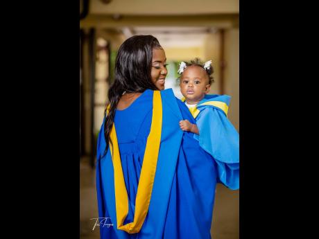 Super mom Asha Watson and her trusted sidekick, Atalia, adorn themselves in graduation ‘capes’ to celebrate Asha’s scholastic achievement.