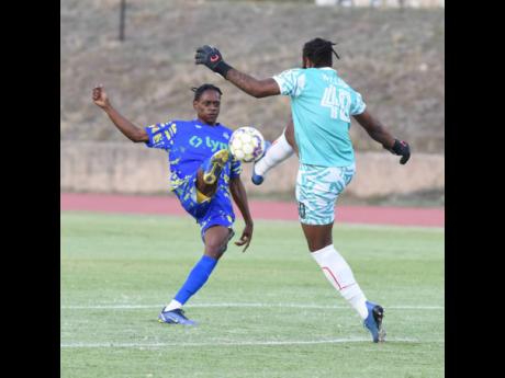 Portmore United's goalkeeper William Benjamin (right) tackles Harbour View's Gavin Burton during their Lynk Cup semifinal match at Stadium East on Friday. The match ended 3-3.