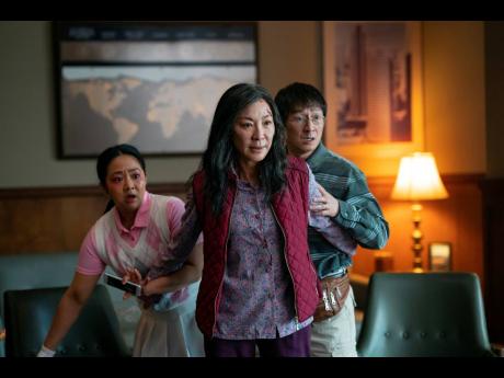 This image released by A24 Films shows (from left), Stephanie Hsu, Michelle Yeoh and Ke Huy Quan in a scene from, ‘Everything Everywhere All At Once’.