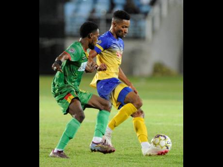 Mark Rodney (right) of Humble Lion tackles Timar Lewis of Harbour View during their Jamaica Premier League (JPL) quarter-final match at Sabina Park last night. Harbour View on 2-0.