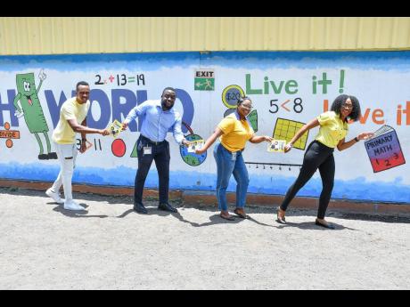 Ready, set, read!
Olympian and National Commercial Bank Jamaica Limited (NCB) Brand Ambassador Julian Forte starts NCB’s Reading Relay on a solid footing by passing the baton to Stephen Reid, son of late NCB executive Stuart Reid. Next up is Simone Barne