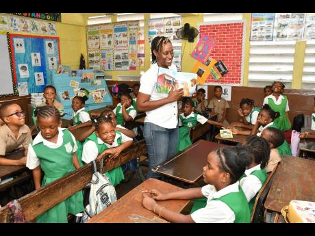 ‘Jamaica is My Tummy’ brings smiles to children’s faces
Malikah Peart, lead of the Agile Centre of Excellence at National Commercial Bank Jamaica Limited, delights grade-one students at Pembroke Hall Primary School on Read Across Jamaica Day 2023 by 