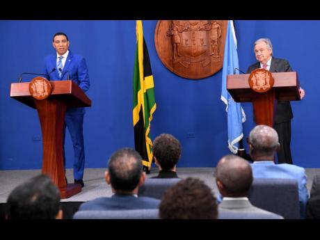 Prime Minister Andrew Holness (left) and United Nations Secretary-General Antonio Guterres address the media at a joint press conference at Jamaica House Media Centre in Kingston yesterday.