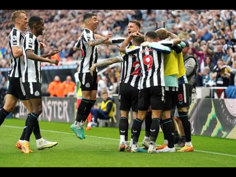 Newcastle United celebrate after Brighton and Hove Albion’s Deniz Undav scored an own goal during the English Premier League match at St James’ Park, Newcastle, England, yesterday