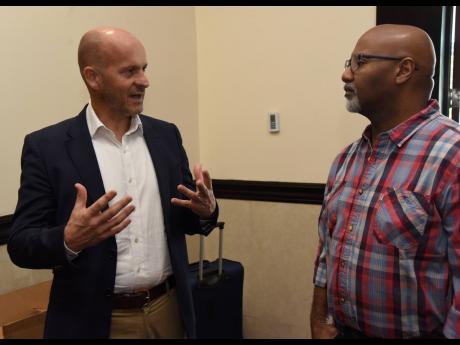 Rob Eyers (left), Unified Technology’s senior vice president, business development for the English-speaking Caribbean, Unified Technology, in conversation with Garfield Gordon (right,) IT technology consultant. 