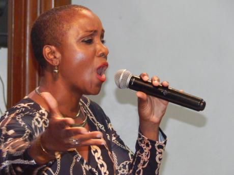  Soloist Ellan Neil belts out one of her songs at the Philharmonic Orchestra of Jamaica concert on Saturday night in The University Chapel.