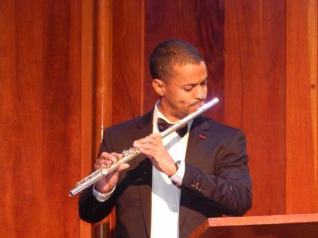 Brian Morris playing his flute at the Philharmonic Orchestra of Jamaica  concert in The University Chapel.