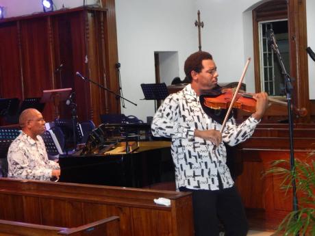 Father and son composers Jon Williams (left, at the piano) and Jovani Williams (on viola) playing in The University Chapel on Saturday night.