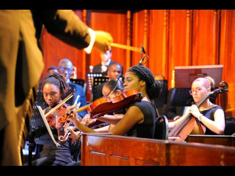 Members of the Philharmonic Orchestra of Jamaica, led by Franklin Halliburton, perform at  The University Chapel UWI Mona, St Andrew, on May 20.