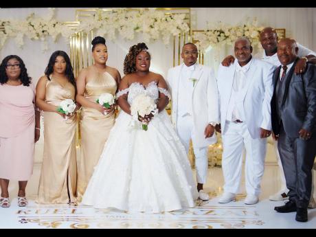 There's nothing more amazing than having the support of the bridal party as the couple walk into 'I do'. From left: Adassa Ennis, mother of the bride; Andreen Wierenga, niece of bride; Ashley McElroy, maid of honour; the bride and groom, Michale Elliott, f