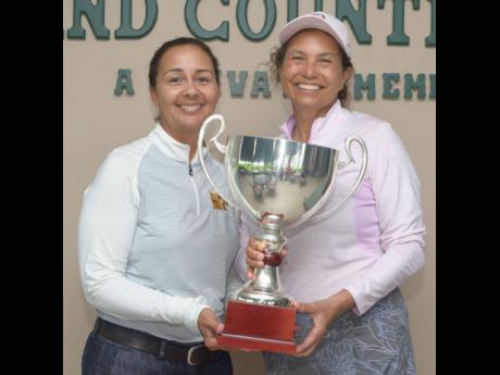 President of the Jamaica Golf Association Jodi Munn Barrow (left) presents the National Amateur Golf Championship trophy to Michelle McCreath. 