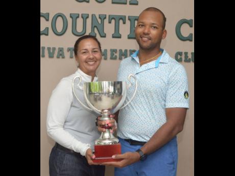 President of the Jamaica Golf Association Jodi Munn Barrow (left) presents the National Amateur Golf Championship trophy to William Knibbs.