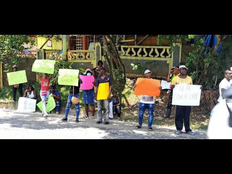 Members of Friends of the Rio Cobre demonstrating in Linstead yesterday, demanding the National Environment and Planning Agency make public results of tests it has conducted in the Rio Cobre at Zapherton, Linstead in St Catherine.