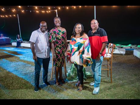 Sagicor Bank Chief Executive Officer Chorvelle Johnson Cunningham (second left) and Nicola Speid (second right), SME business banking manager, take a break from socialising to snap a picture with clients John Surdeen (left) and Solomon Chin.