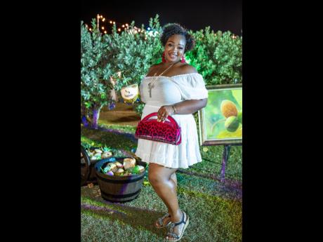 Tour operator and teacher Lathalia Anderson stuns in white and an accent purse. 
