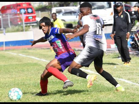 Alex Marshall (left) of Portmore United and Christopher Ainsworth  of Cavalier battle for the ball during a Jamaica Premier League match at  Ashenheim Stadium, Jamaica College on Sunday, April 16, 2023.
