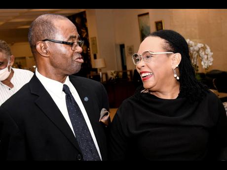 Opposition Senator Donna Scott-Mottley speaks with Heron Thompson, member of the Rotary Club of Kingston, at the Rotary Club’s luncheon meeting at The Jamaica Pegasus hotel in New Kingston yesterday.