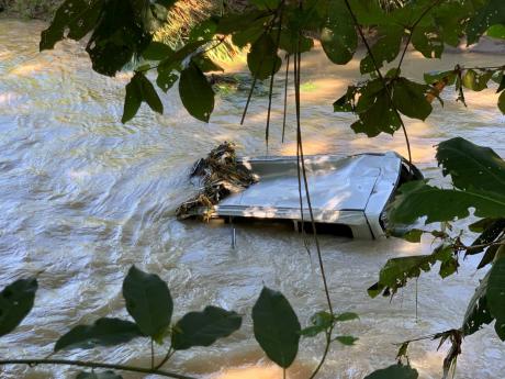 The submerged motor vehicle in which four family members were travelling when it was washed away into the Montego River after overturning into a ditch along the Westgate roadway in Montego Bay, St James, in April 2022. Two of the family members were rescue