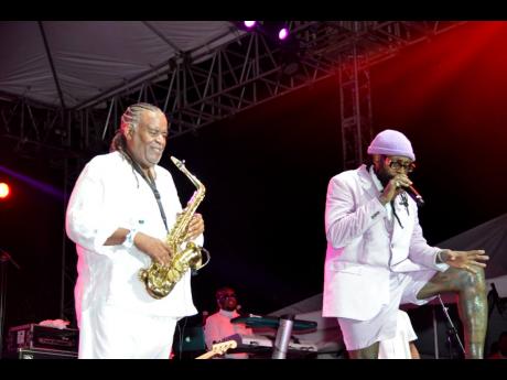 Tarrus Riley (right), is joined onstage by renowned saxophonist Dean Fraser.
