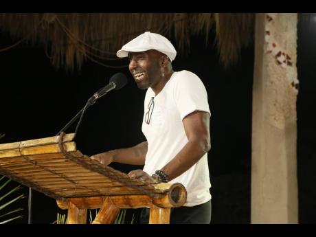 Poet laureates Kei Miller reads during the Laurels and Laureates session on Saturday.