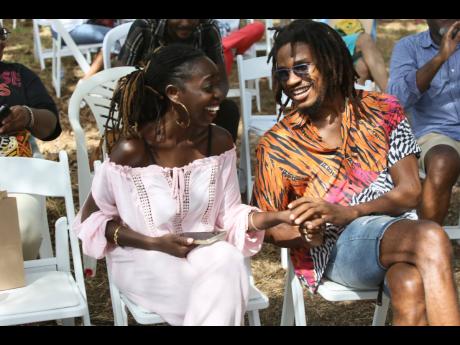 Natasha Griffiths (left), who read her poem ‘Rent a Tile’ speaks with Sheldon Shepherd during open mic on day three of the Calabash International Literary Festival on Sunday.