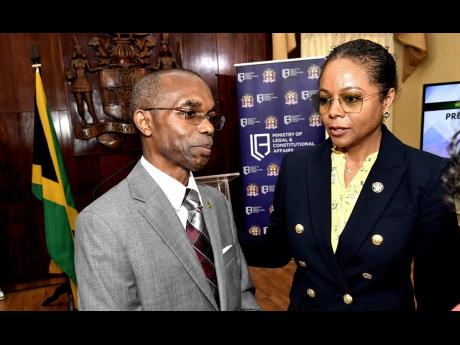 Ambassador Rocky Meade (left), co-chair, Office of the Prime Minister, speaks with Marlene Mahaloo Forte, minister of legal and constitutional affairs, and chair of the Constitutional Reform Committee (CRC), at the meeting to announce members of the CRC at