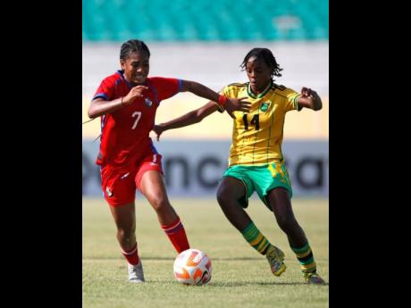 Panama Under-20's Sherline King and Jamaica's Destiny Powell challenge for a ball during their Concacaf Under-20 Women's Championship football game at the Estadio Felix Sanchez in the Dominican Republic this afternoon.  