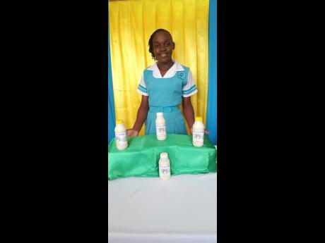 Jamaica 4-H National Girl of The Year, Natoya Williams, shows off her award-winning Cho-Cho Juice, which was one of two projects she entered in the competition held during the National Achievement Expo, which took place recently at the Denbigh Showground i