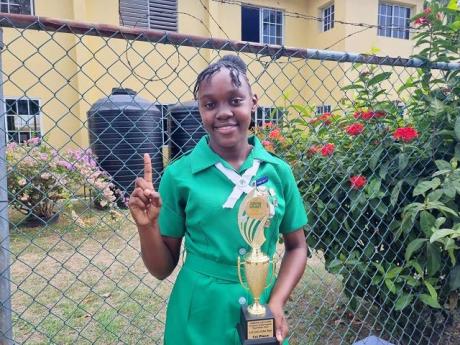 Jamaica 4-H Clubs National Girl of The Year, Natoya Williams, poses with her trophy at the National Achievement Expo held recently at the Denbigh Showground in Clarendon.

 