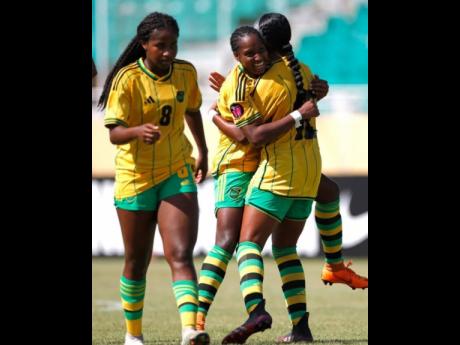 Jamaica Uner-20’s Avery Johnson (left) celebrates a goal with teammates during a Concacaf Under-20 Women’s Championship game against Panama at the Estadio Felix Sanchez in the Dominican Republic yesterday.