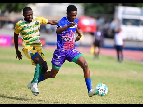 Portmore United’s Shakeon Satchwell (right) dribbles away from Vere United’s Kemmoy Phillips during a  Jamaica Premier League match at Ashenheim Stadium, Jamaica College on Sunday, February 26, 2023. Portmore won 2-0.