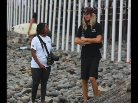 Jamaica’s Javaun Brown (left) and Icah Wilmot head to the beach at Surf City to practice ahead of the start of the ISA World Surfing Games in El Salvador.