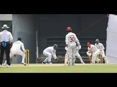 West Indies A captain Joshua da Silva plays forward to a delivery while his partner, Tagenarine Chandperpaul looks on during a ‘Test’ against Bangladesh A at the Sylhet International Cricket Stadium in Bangladesh yesterday.
