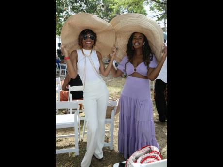 Dr Laurajan Obermuller (left), anthropologist, The University of the West Indies, Mona campus, and gal pal Zaneta Scott, environmental planner, Housing Agency of Jamaica, take shelter from the sun in large wide-brimmed floppy hats.