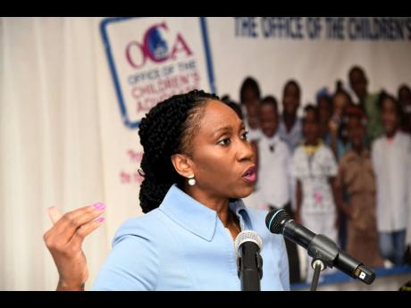 Diahann Gordon Harrison, children’s advocate, makes a presentation on data gathered from responses to the national child and teen helpline, Safespot, at the Terra Nova All-Suite Hotel in Kingston on Wednesday, May 17.