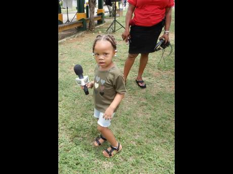 Two-year-old Xaviah Keize, with an Irie FM branded microphone in hand, was spotted at the men’s health fair in Ocho Rios.