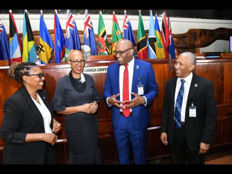 Minister of Education and Youth Fayval Williams (second left), shares in light discussion with (from left) Director of the University of the West Indies (UWI) School of Education, Dr Marcia Rainford; St Lucia’s Minister of Education, Sustainable Developm