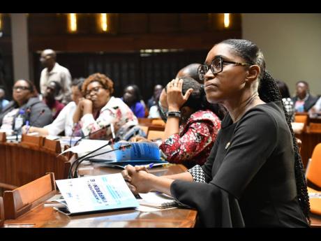 Principal of the Vocational Training and Development Institute, Delize Williams (right), is attentive during the sixth International Conference on Technical and Vocational Education and Training  in the Caribbean, held recently at the Jamaica Conference Ce