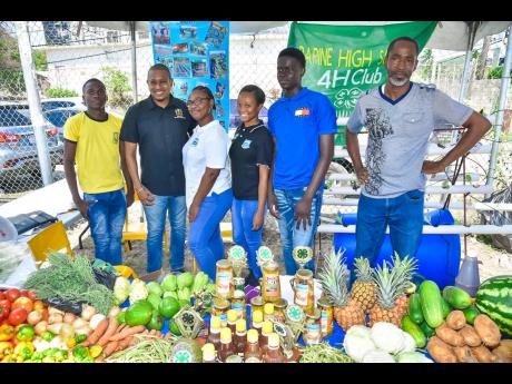 Minister of Agriculture, Fisheries and Mining Floyd Green (second left), with representatives from the Papine High School 4-H Club during the 2023 Agricultural Show (Agrofest) for Kingston and St Andrew. They are (from left) students Andrew Matthewson; Jes