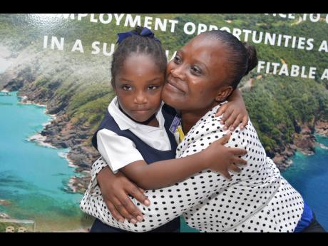 St Catherine Primary School student, Sarah-Kay Campbell embraces her teacher, Sanika Roberts during the Insurance Company of the West Indies (ICWI) ‘Dream Big’ Teachers’ Day presentation ceremony held at the New Kingston head offices of the ICWI on M
